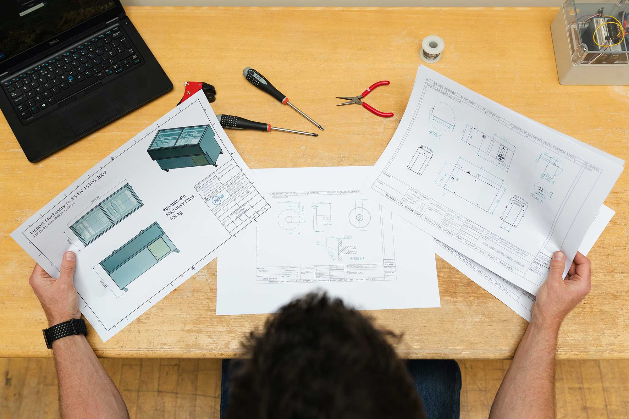 Man holding engineering notes